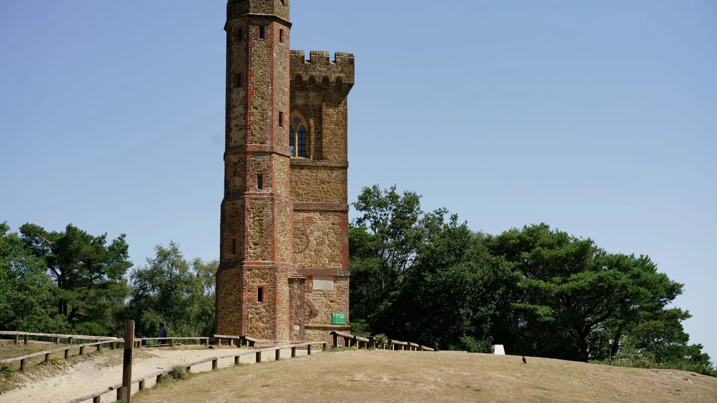The brick and stone Leith Hill Tower on the summit of Leith Hill, near Dorking, against a blue sky