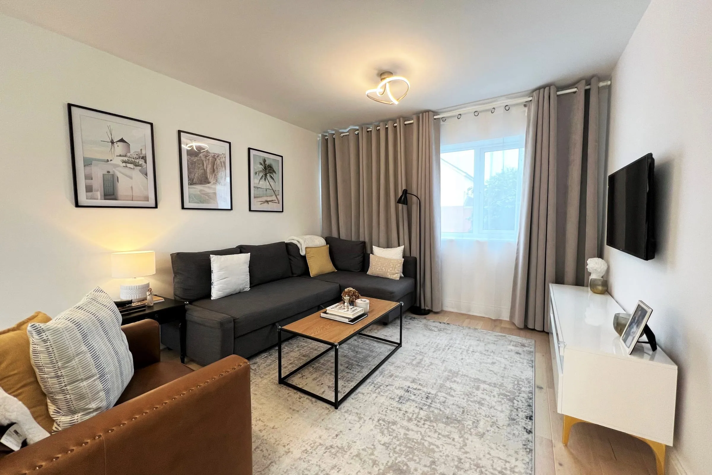 The new living room in the extended end-of-terrace house in Woking, with a corner sofa and a large window