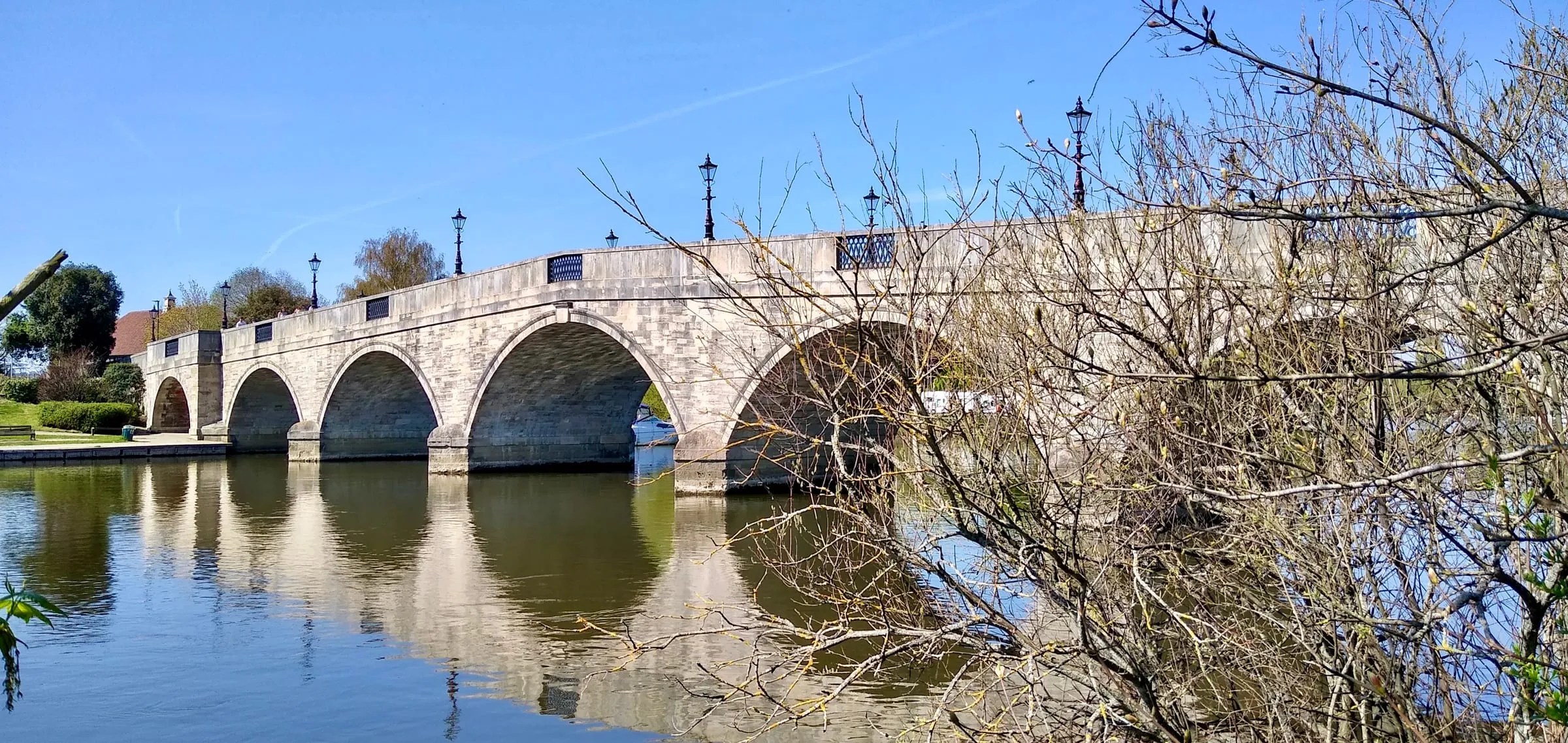 Chertsey Bridge, a stone arched bridge over the River Thames, seen from the east bank