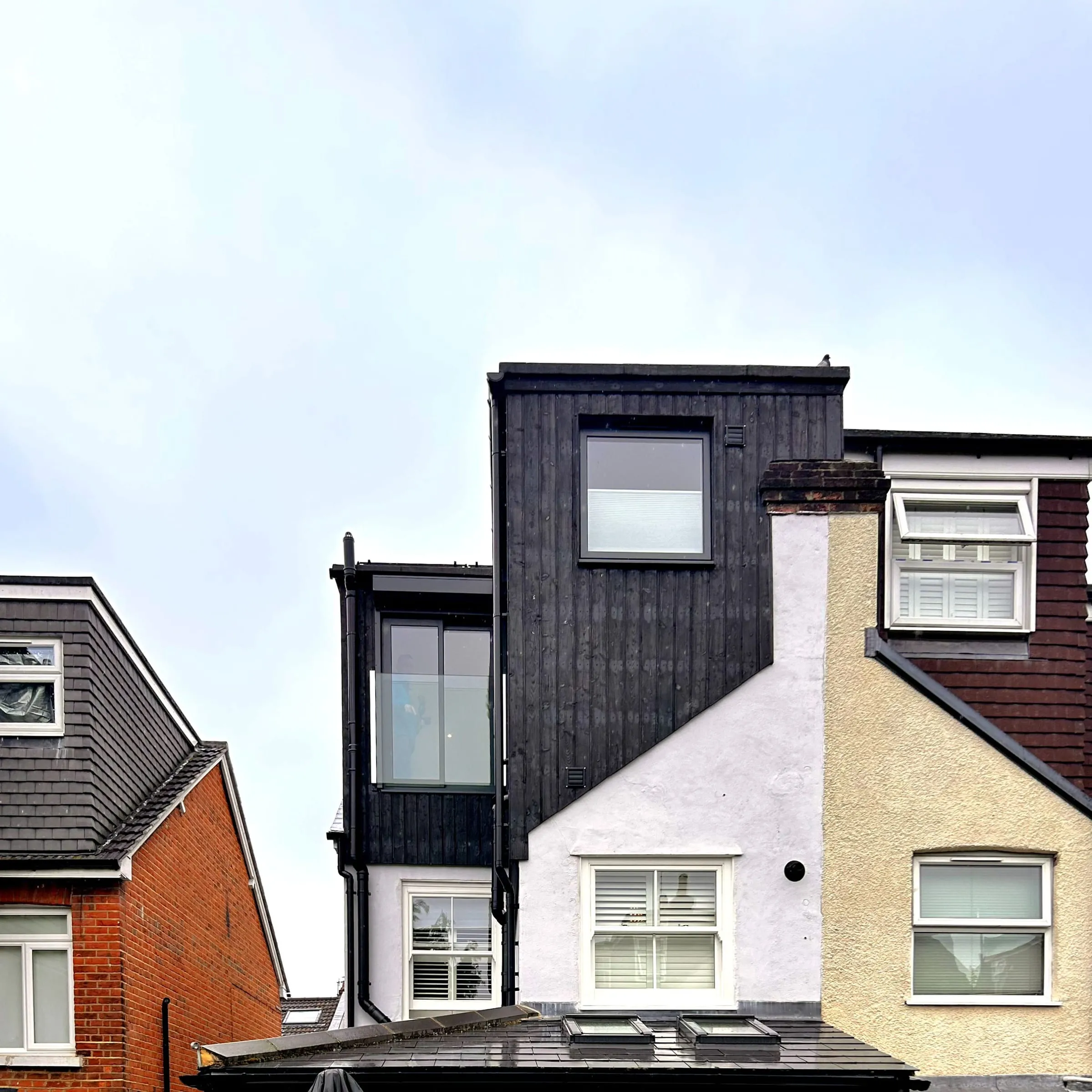 The rear dormer of the Guildford townhouse loft conversion, clad in dark timber above the existing roof