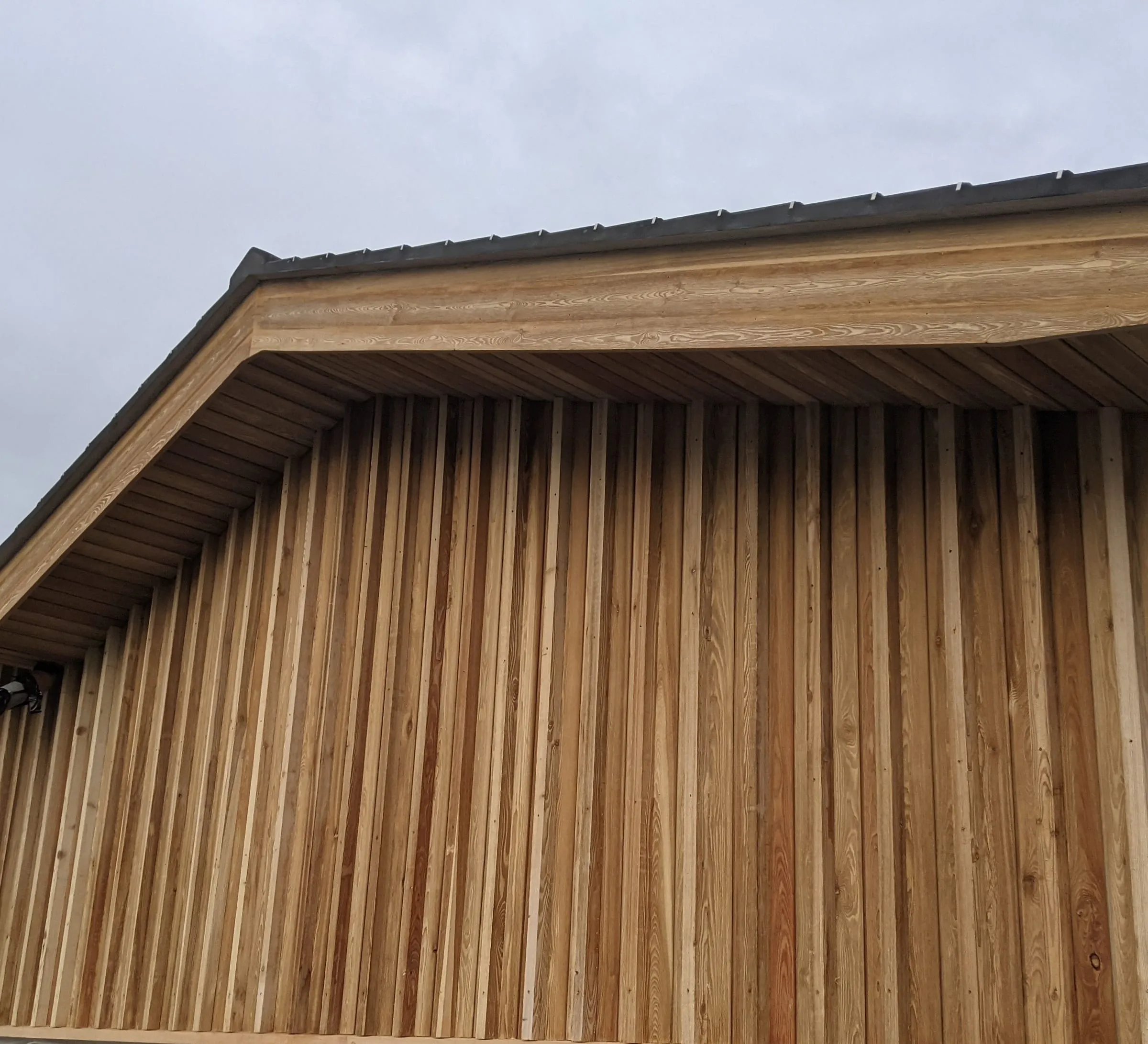 The larch-clad gable under the new roof, photographed during construction