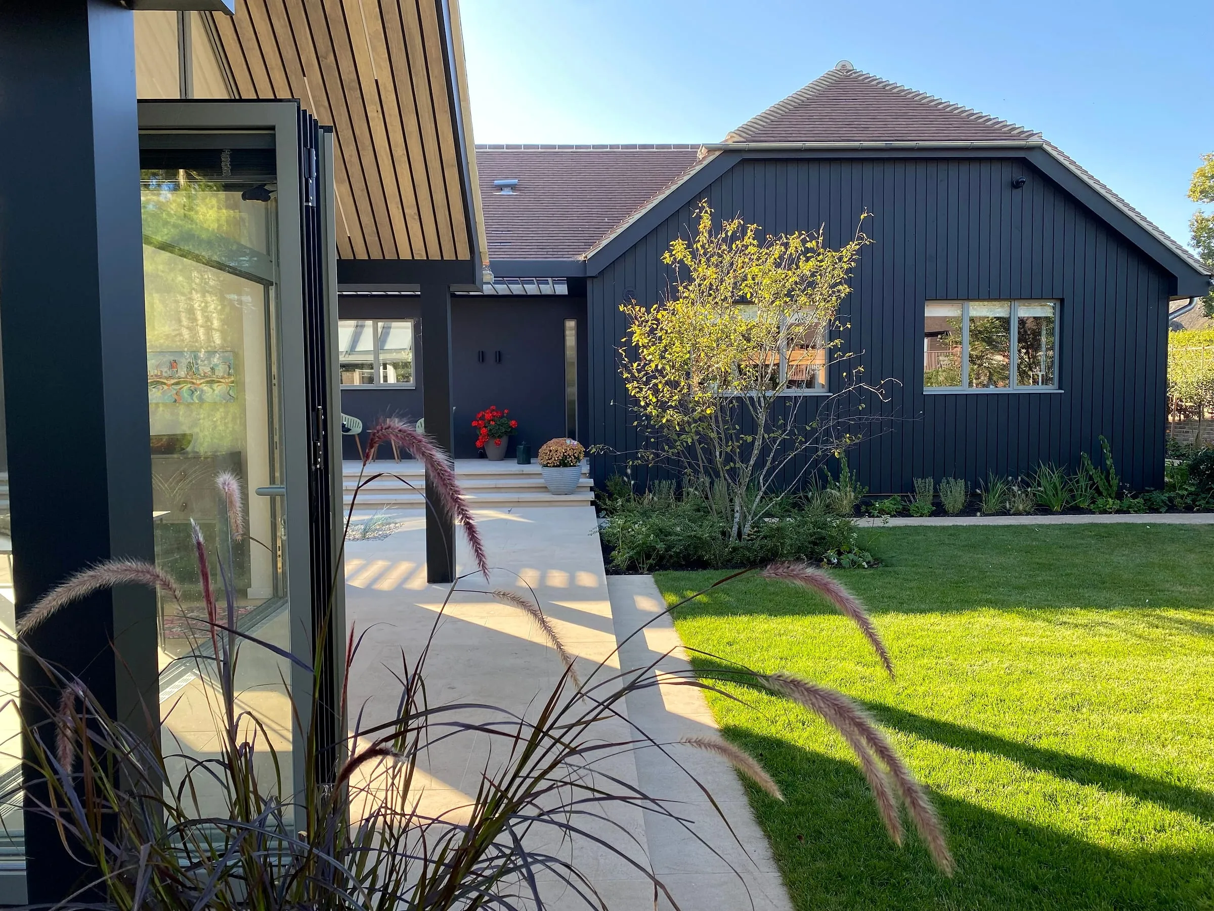 The garden room across the lawn, with the main house beyond