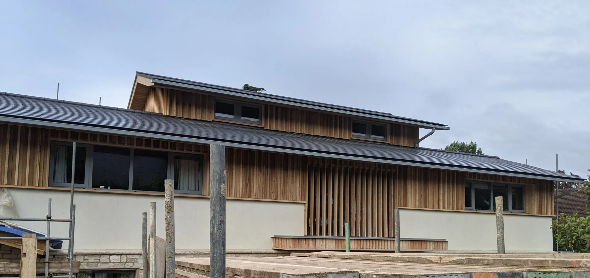 The whole front of the house from the scaffold, the new roof and clerestory over the larch and render